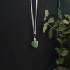 small crystal sphere of green aventurine, bound in a simple silver look wire wrap onto a dainty silver plated chain