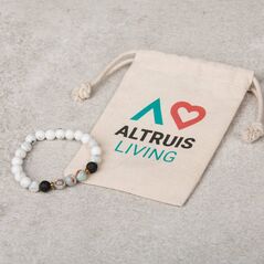 A bracelet with white organic cotton jewellery pouch