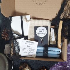Peace spell box containing blue candles, palo santo stick, jar of dried lavender, a handmade amethyst sphere crystal necklace on dainty silver chain and an original ritual wrote by a  witch