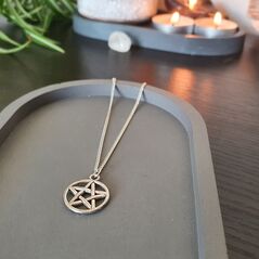 Silver coloured pentacle pendant on dainty silver chain. Pentacle charm is about the size of a pound coin